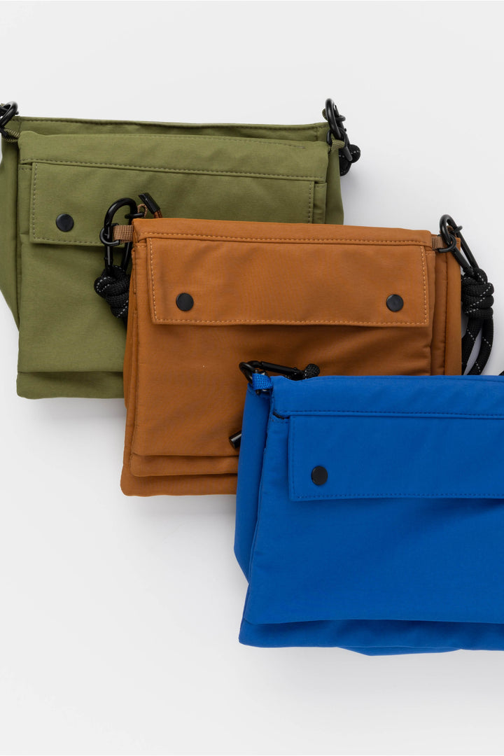 Three bags in green, orange, and blue on a white background