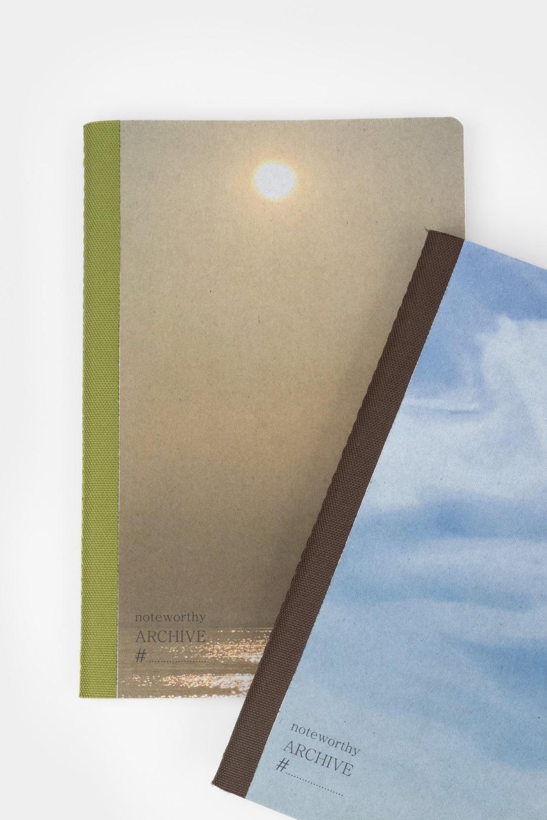 Two books a5 notebooks with covers featuring the sun and blue sky