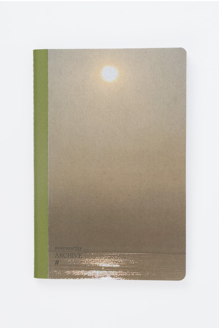 Notebook with cover image of sun and sea