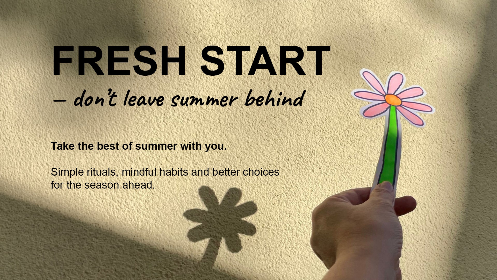 A hand holds a paper flower with a green stem and pink petals against a textured beige wall with shadows. Large text reads “FRESH START — don’t leave summer behind” with smaller motivational copy below.