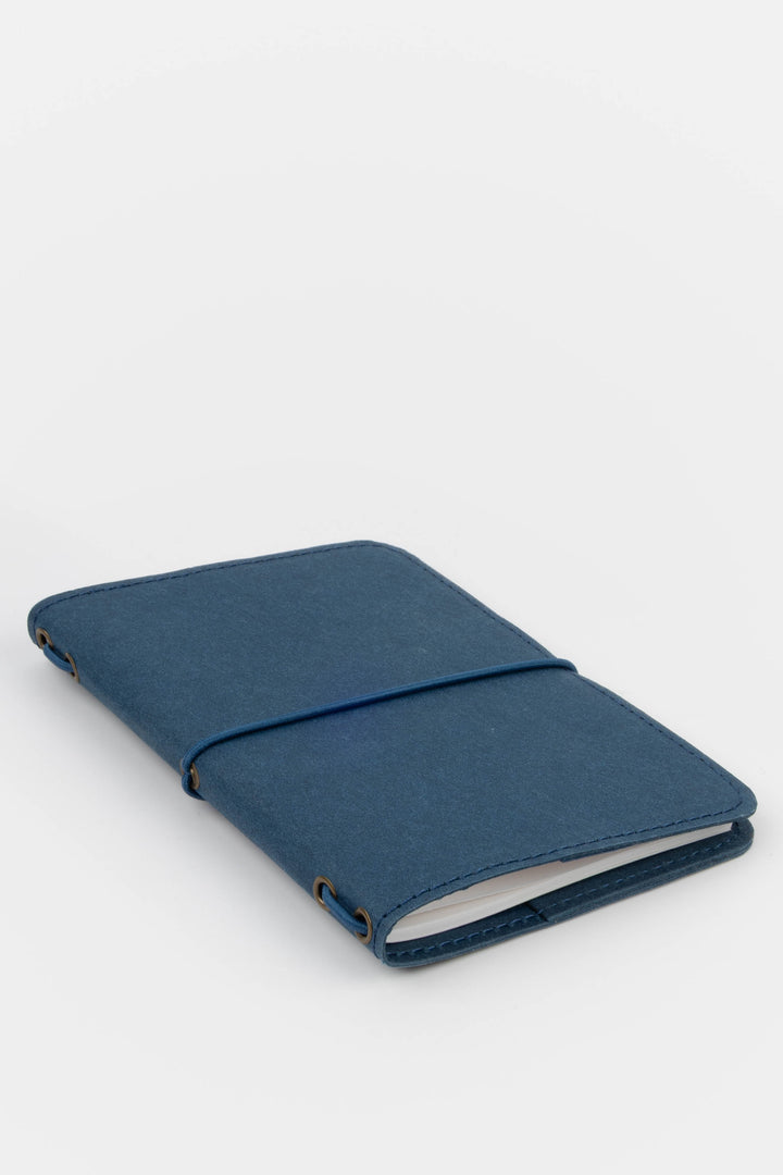 Blue passport size sketch journal on a white background