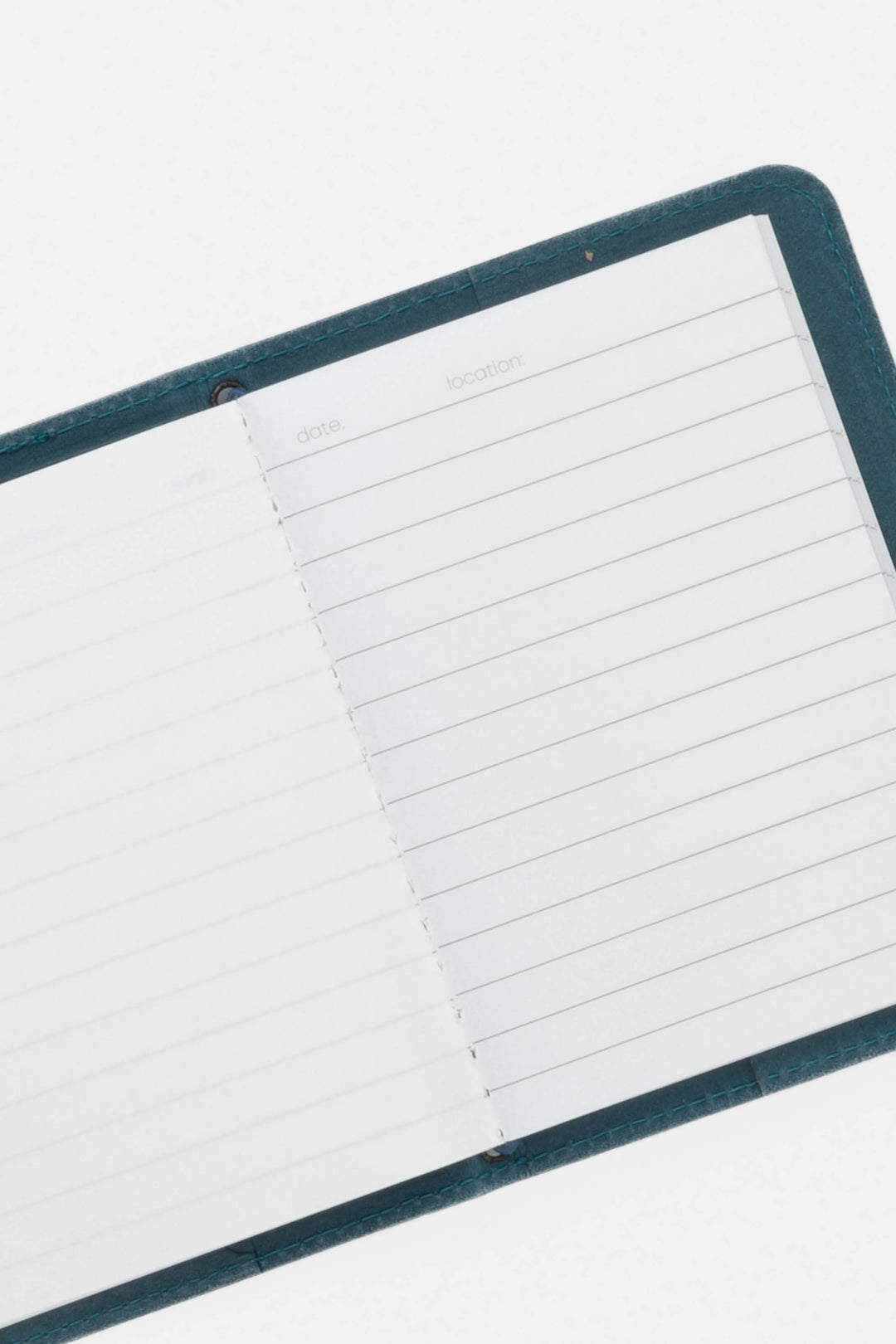 opened blue passport size sketch journal with lined and blank pages 