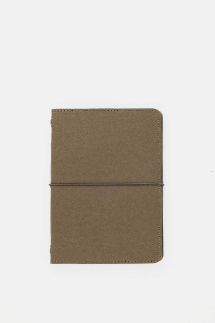 green passport size sketch journal on a white background