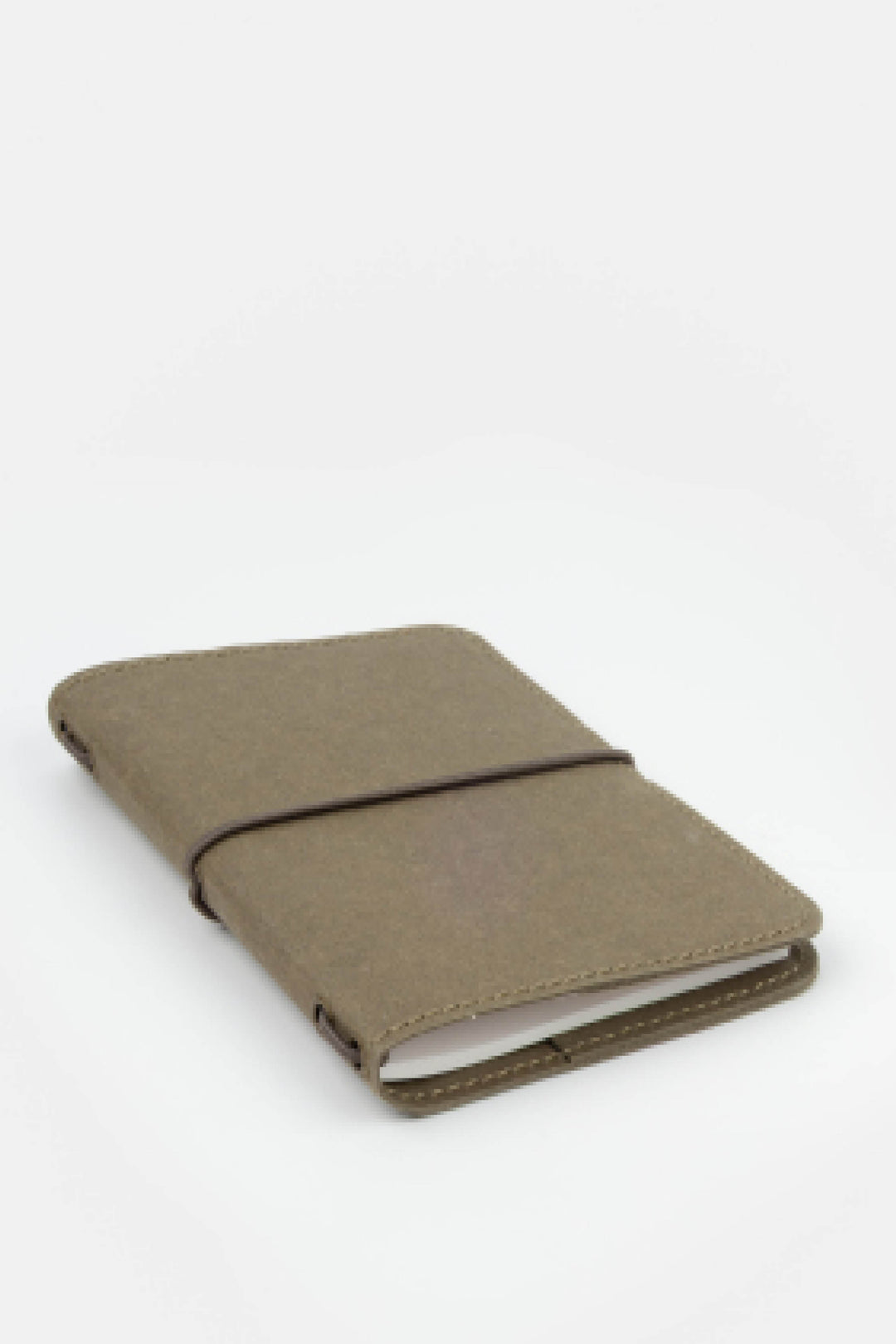 green passport size sketch journal on a white background