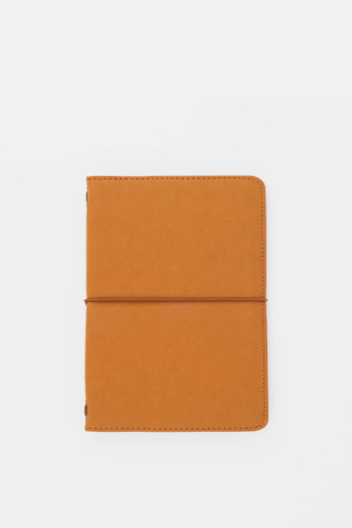 Orange passport size sketch journal on a white background