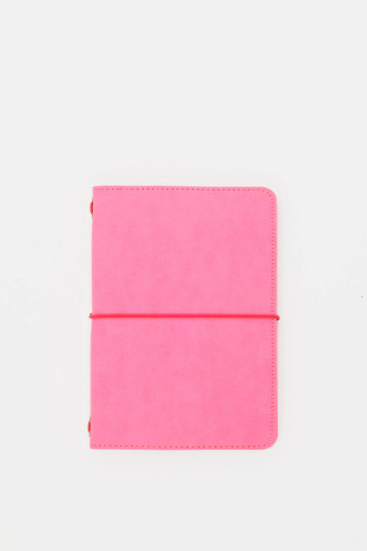Pink passport size sketch journal on a white background