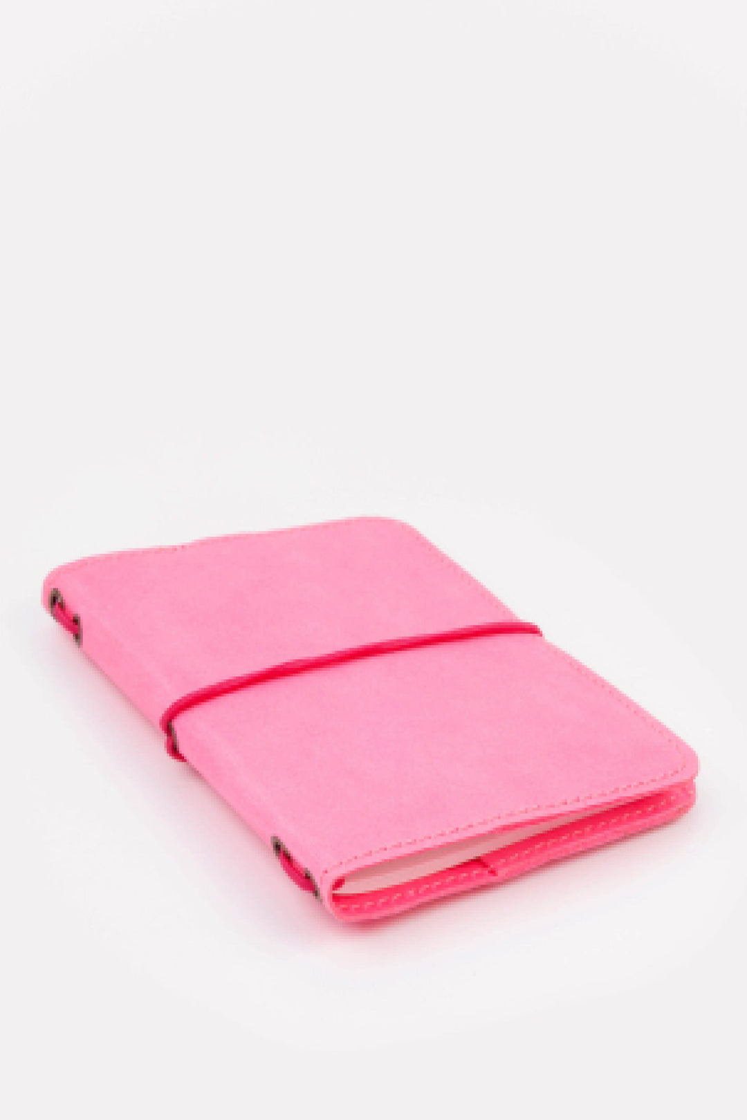 Pink passport size sketch journal on a white background