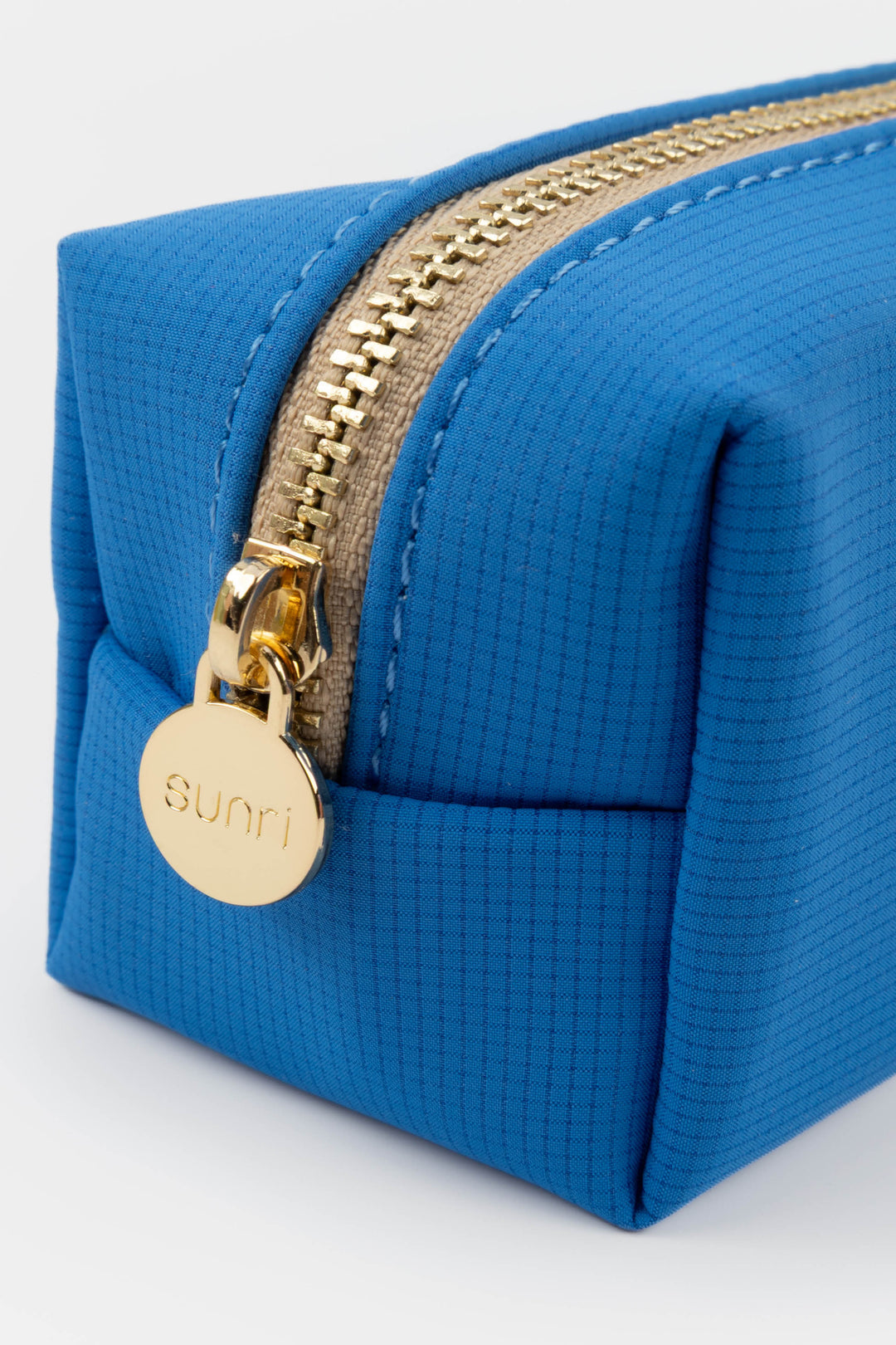 Blue pencil case with gold zipper and 'Sunri' brand logo on a white background