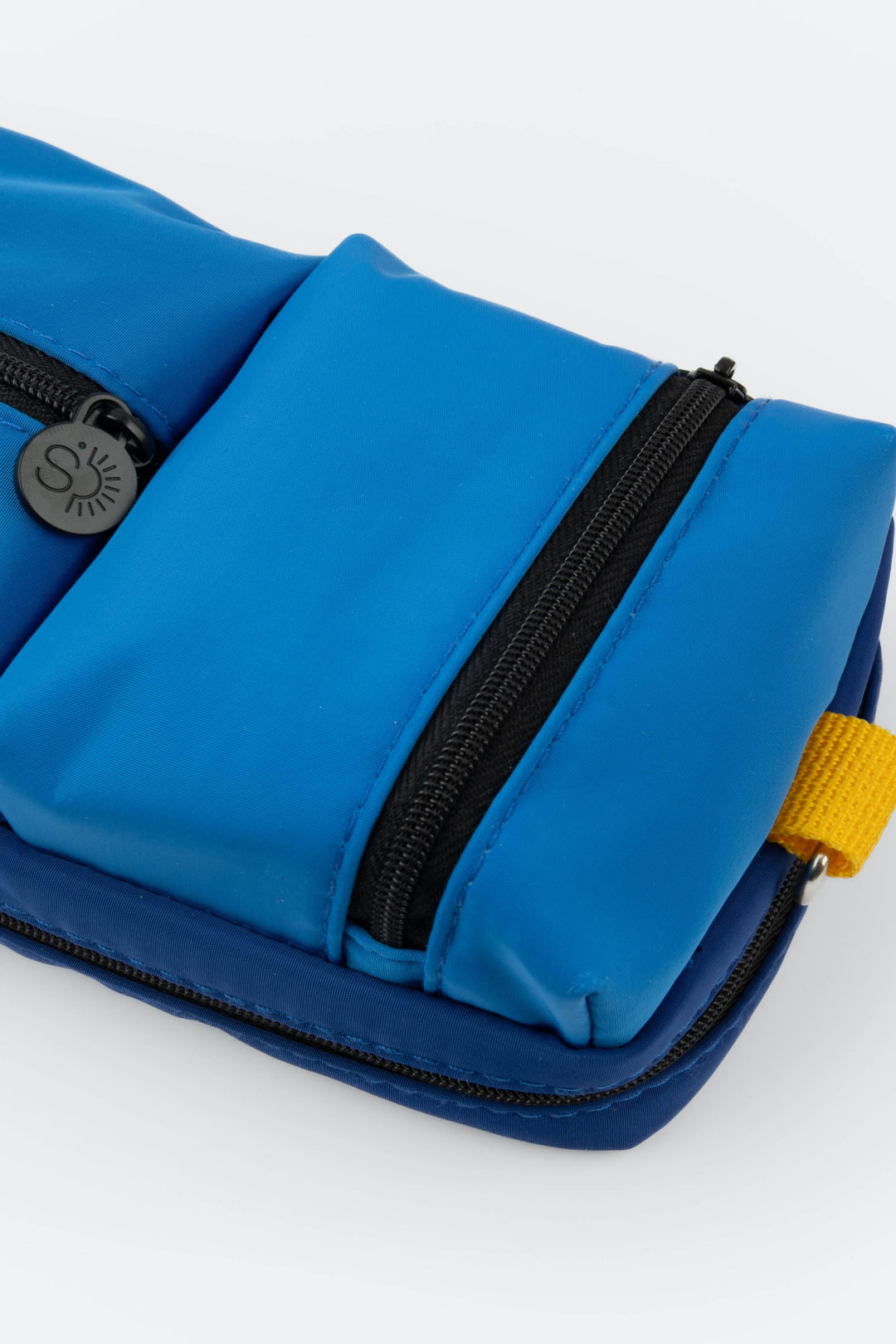 Blue pouch with black zipper and yellow tag on a white background