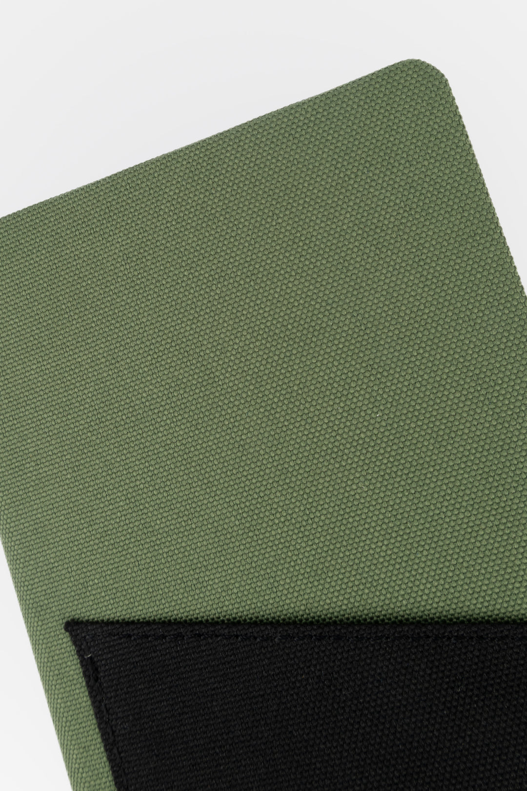 Close-up of green fabric texture on the pocket notebook cover

