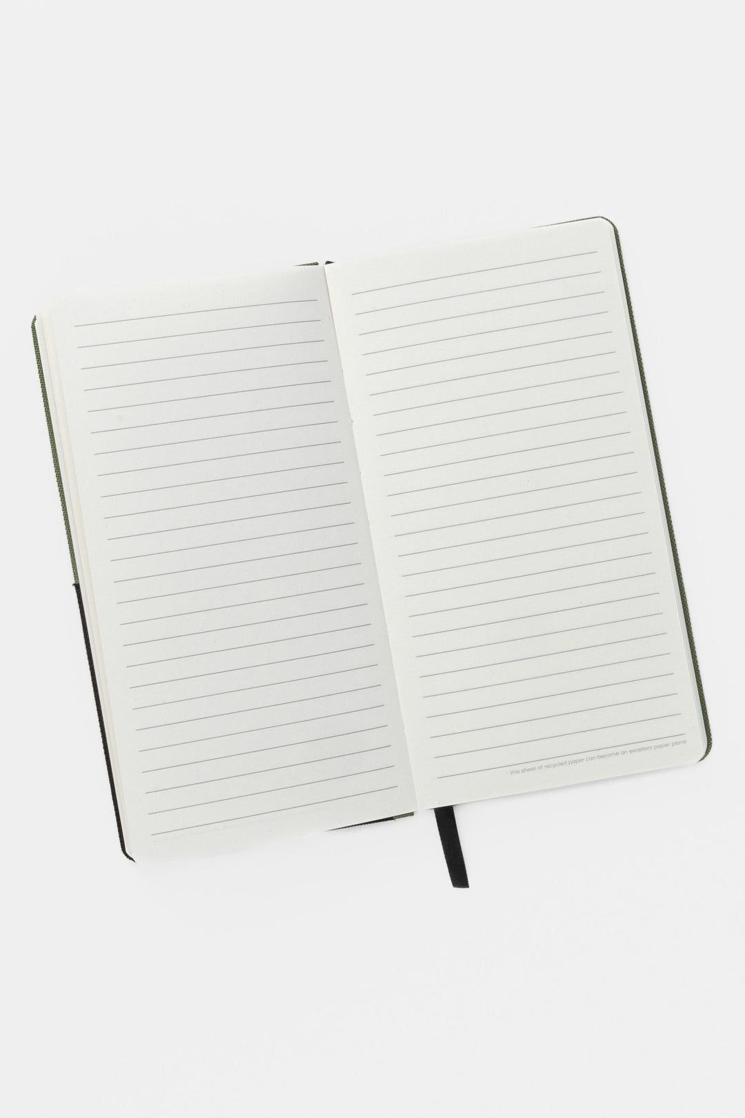 Open pocket notebook showing ruled pages and black ribbon marker
