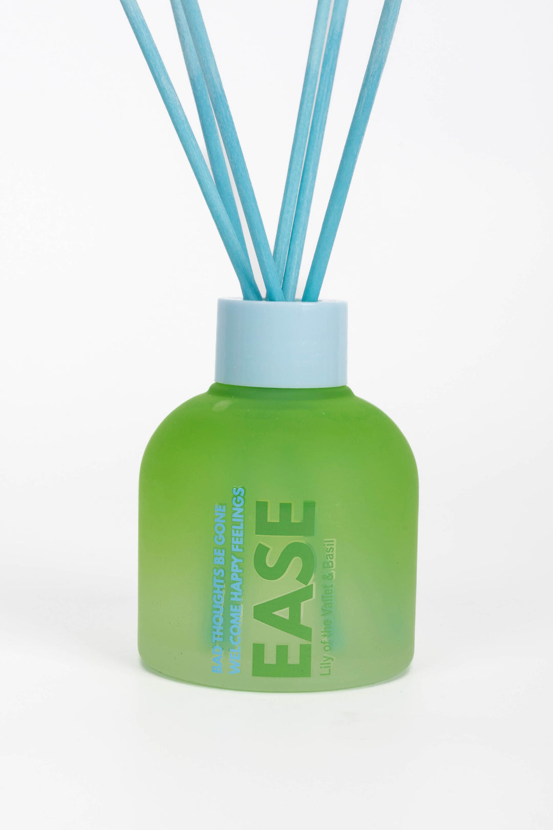 Green diffuser bottle labeled 'Ease' with blue sticks on a white background