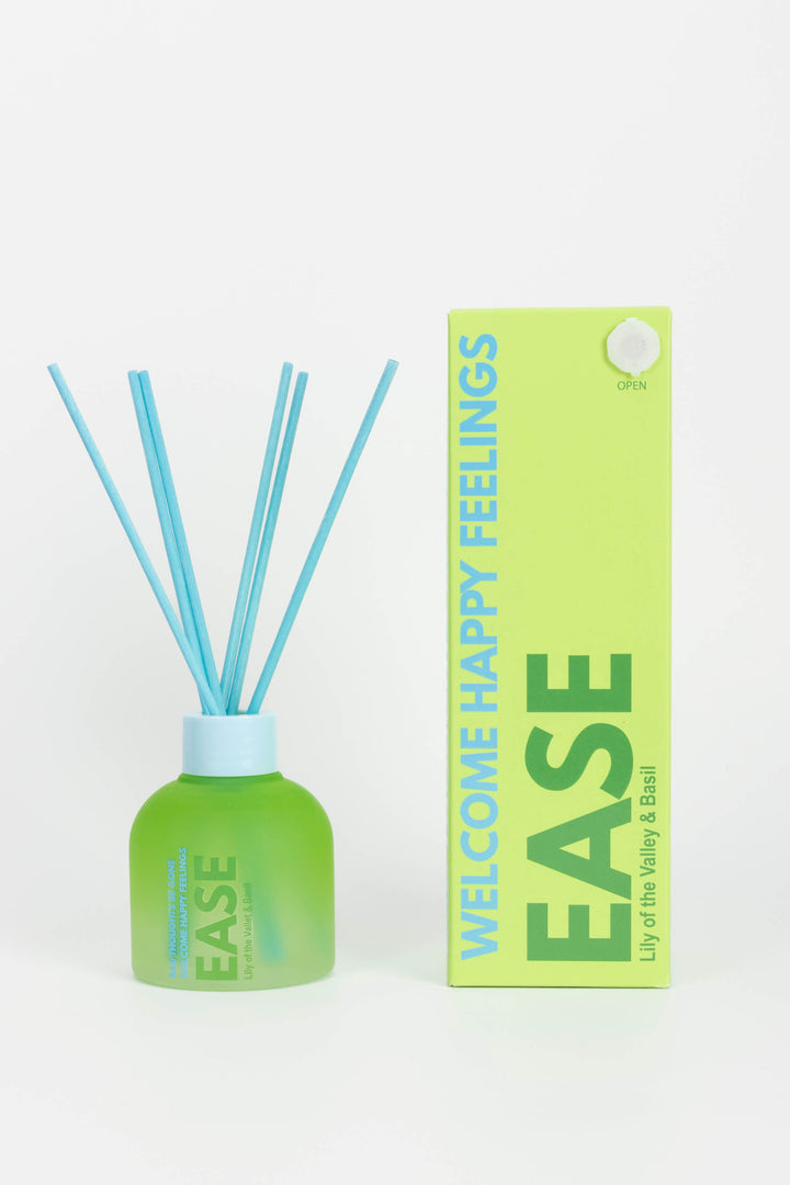 Green diffuser bottle with blue sticks and matching packaging on a white background