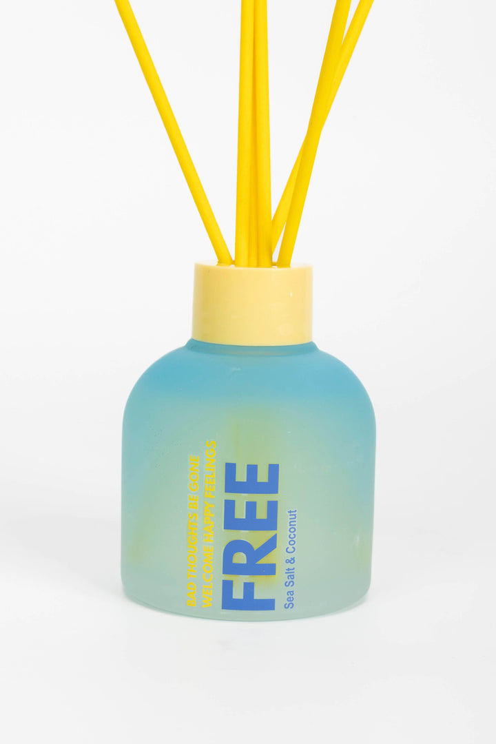 Diffuser with yellow sticks and a blue gradient bottle on a white background