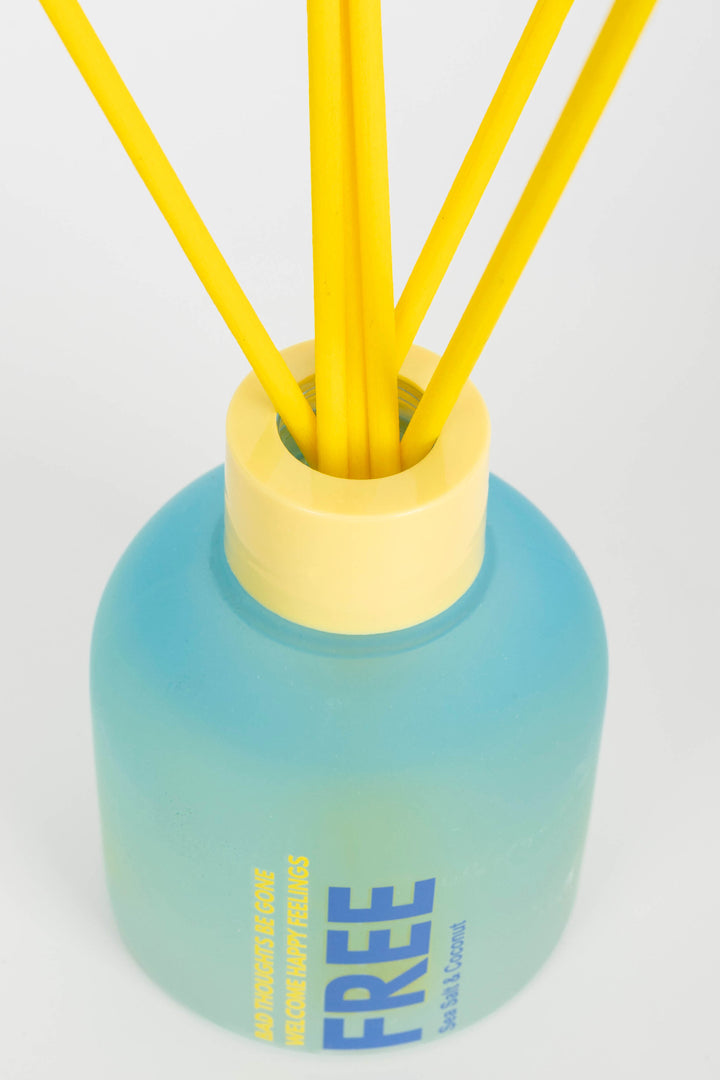 Blue and yellow diffuser with reeds on a white background