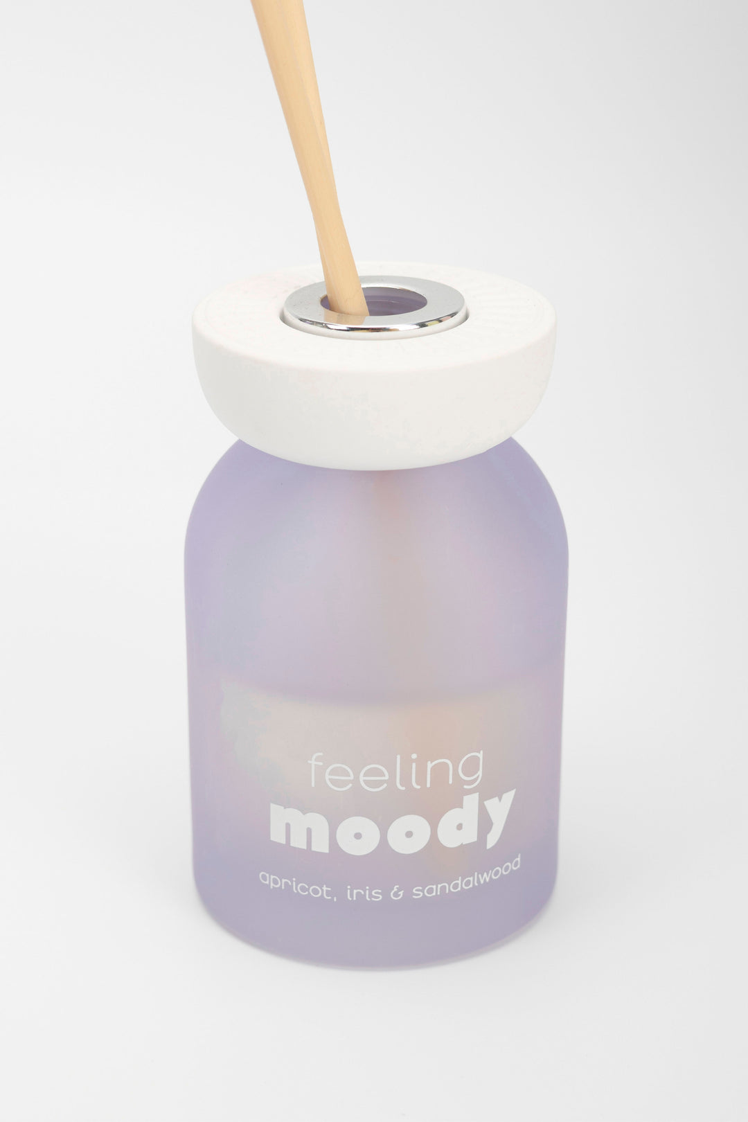 Purple diffuser bottle with a white cap and 'feeling moody' text on a white background