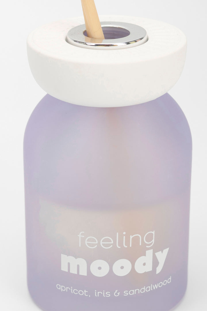 Gradient bottle with 'feeling moody' text and a straw on a white background