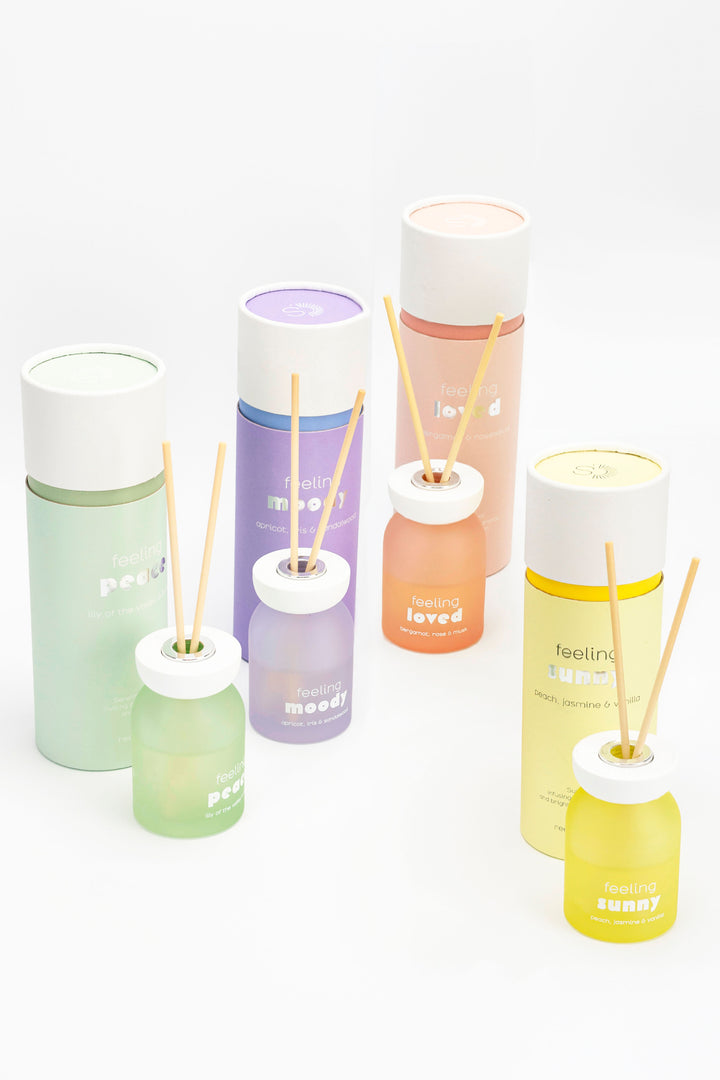 Set of colorful diffusers with sticks on a white background