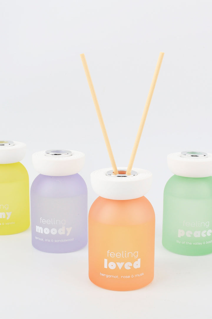 Set of colorful diffusers with wooden sticks on a white background