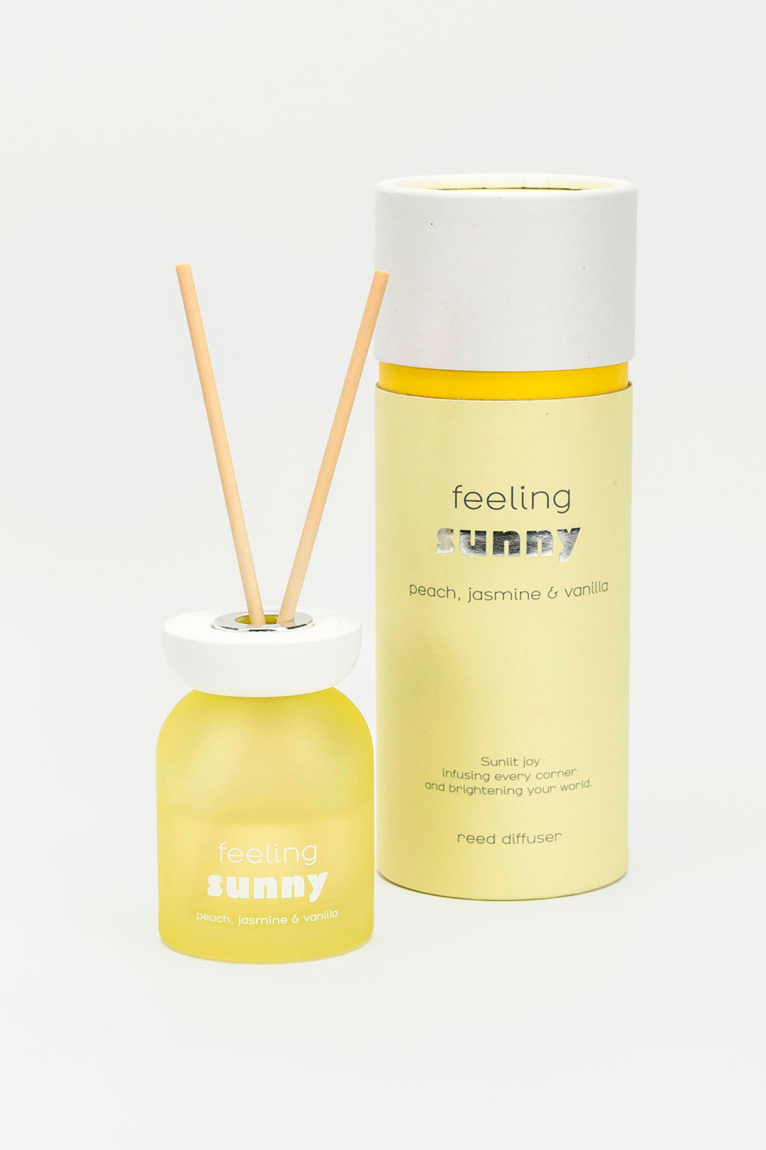 Yellow diffuser with reeds and cylindrical container labeled 'feeling sunny' on a white background