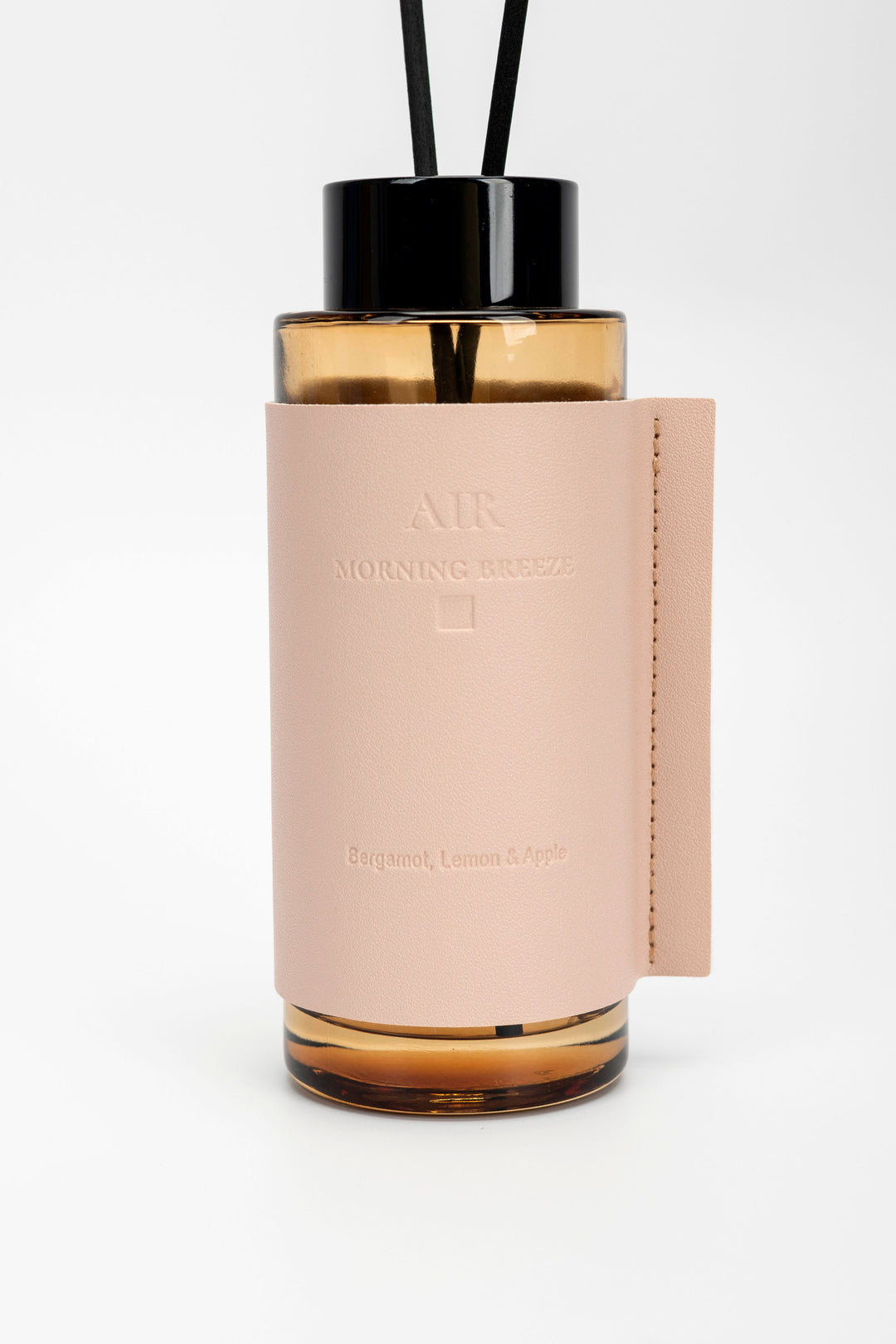 Diffuser with pink cover and black top on a white background