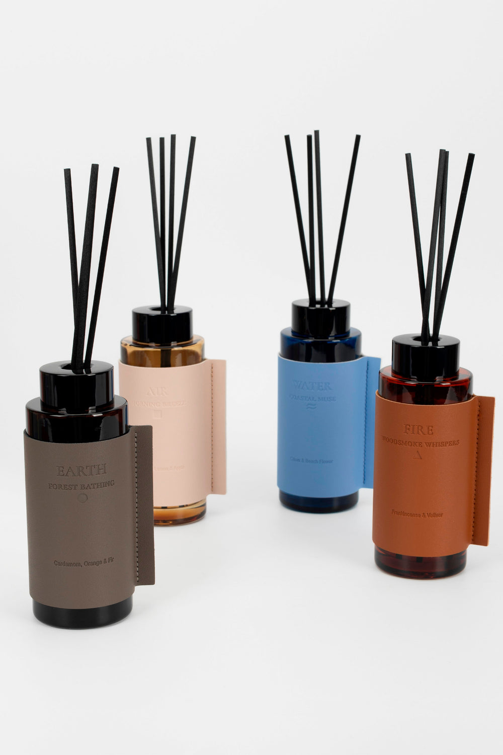 collection of 4 different coloured diffusers with black reeds