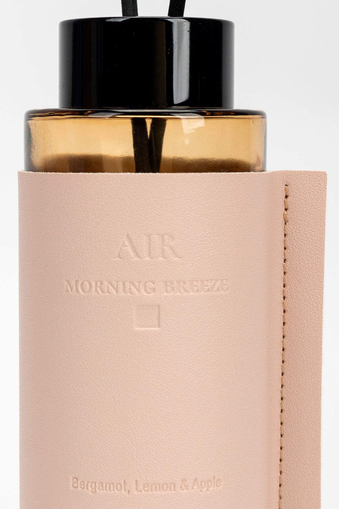 Diffuser bottle labeled 'Morning Breeze' with beige cap and beige body on a light gray background