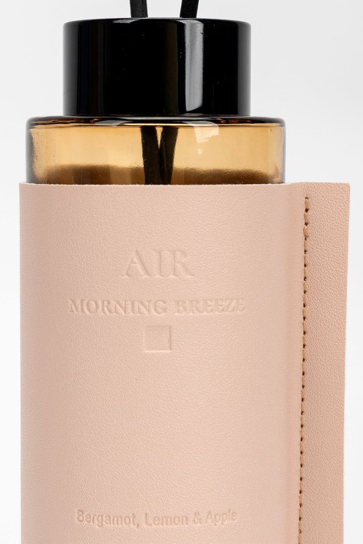 Diffuser bottle labeled 'Morning Breeze' with beige cap and beige body on a light gray background