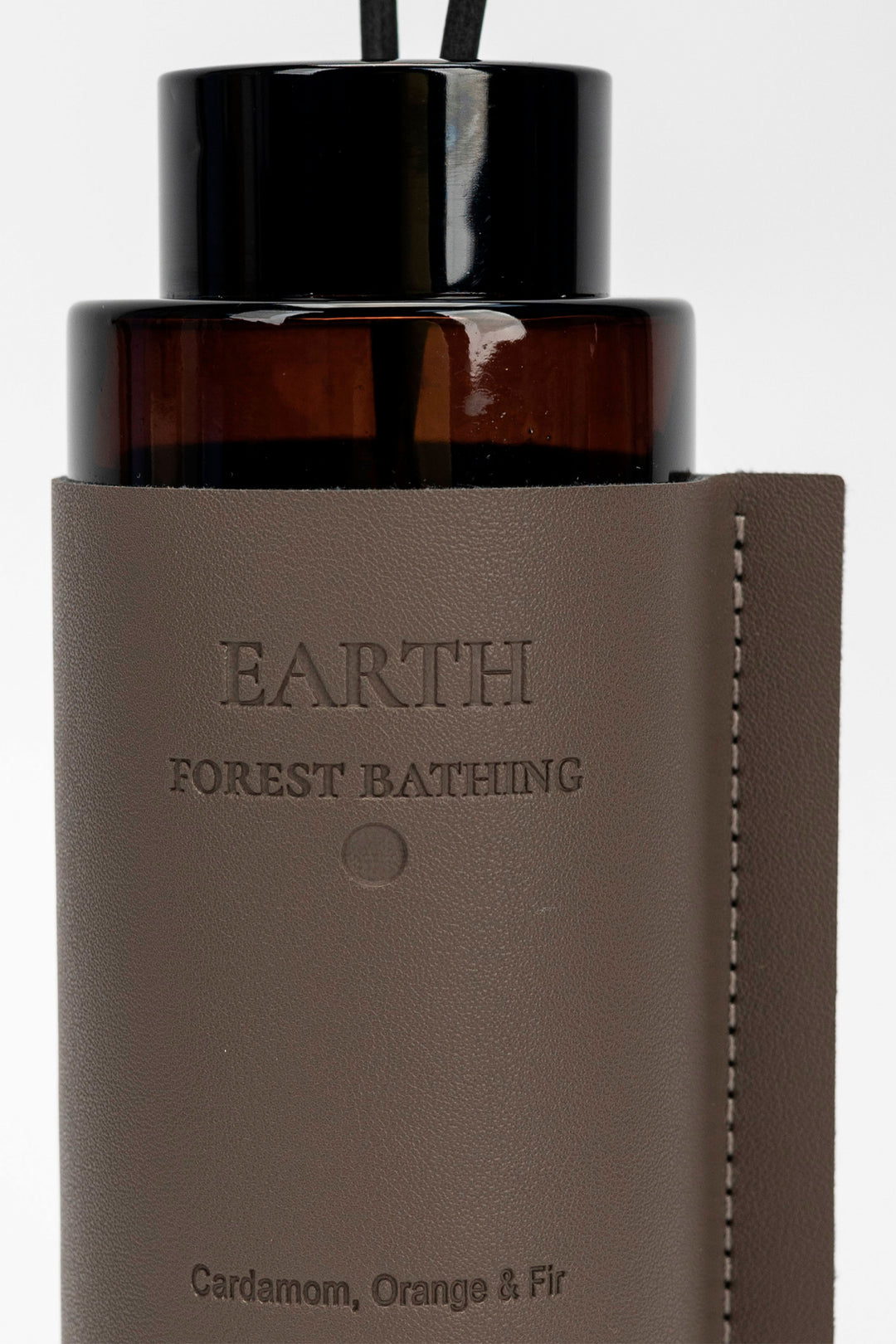 Brown diffuser bottle with Earth Forest Bathing label.
