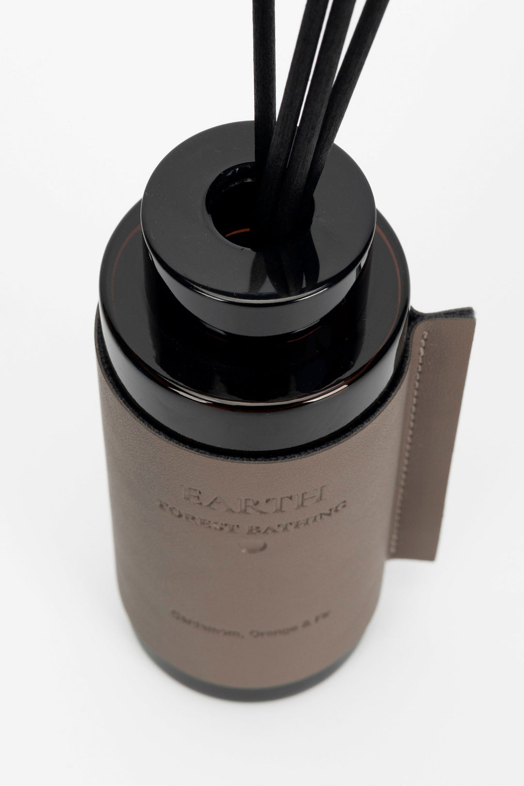 Brown diffuser bottle with Earth Forest Bathing label.