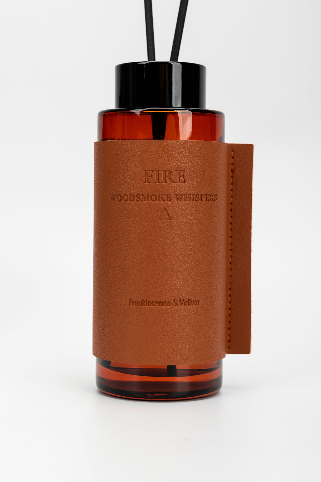 Brown leather and black glass diffuser with 'FIRE' branding on a white background