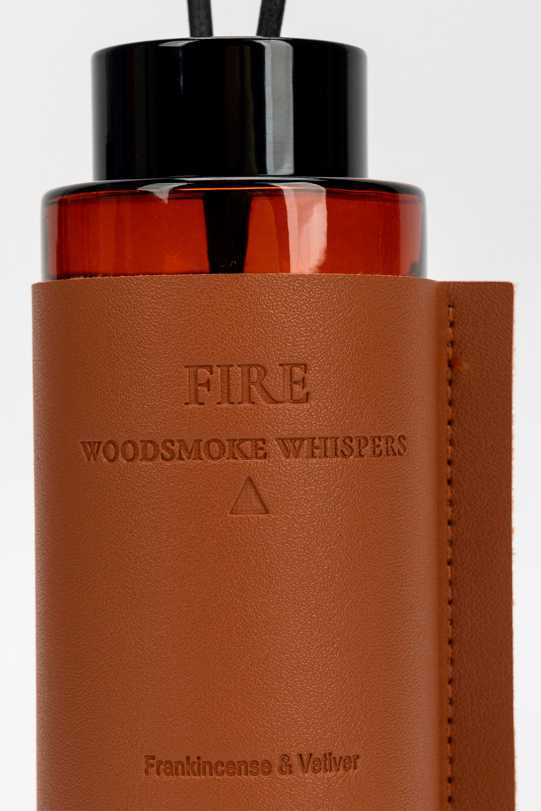 Brown diffuser with black top on a white background