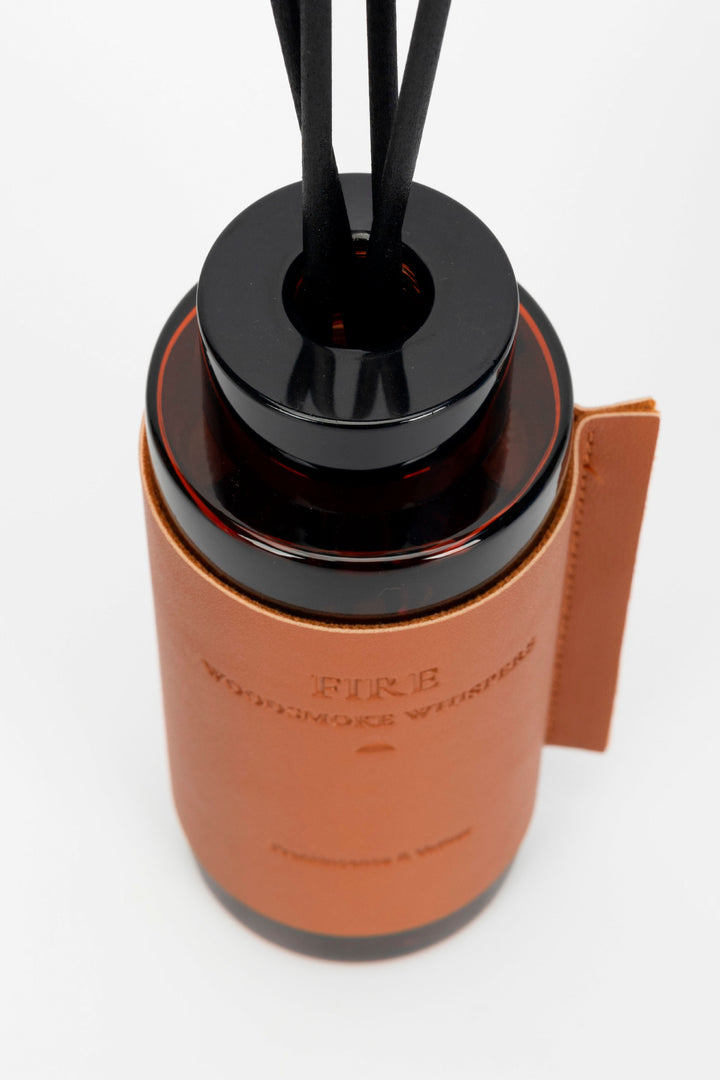 Brown diffuser with black top on a white background