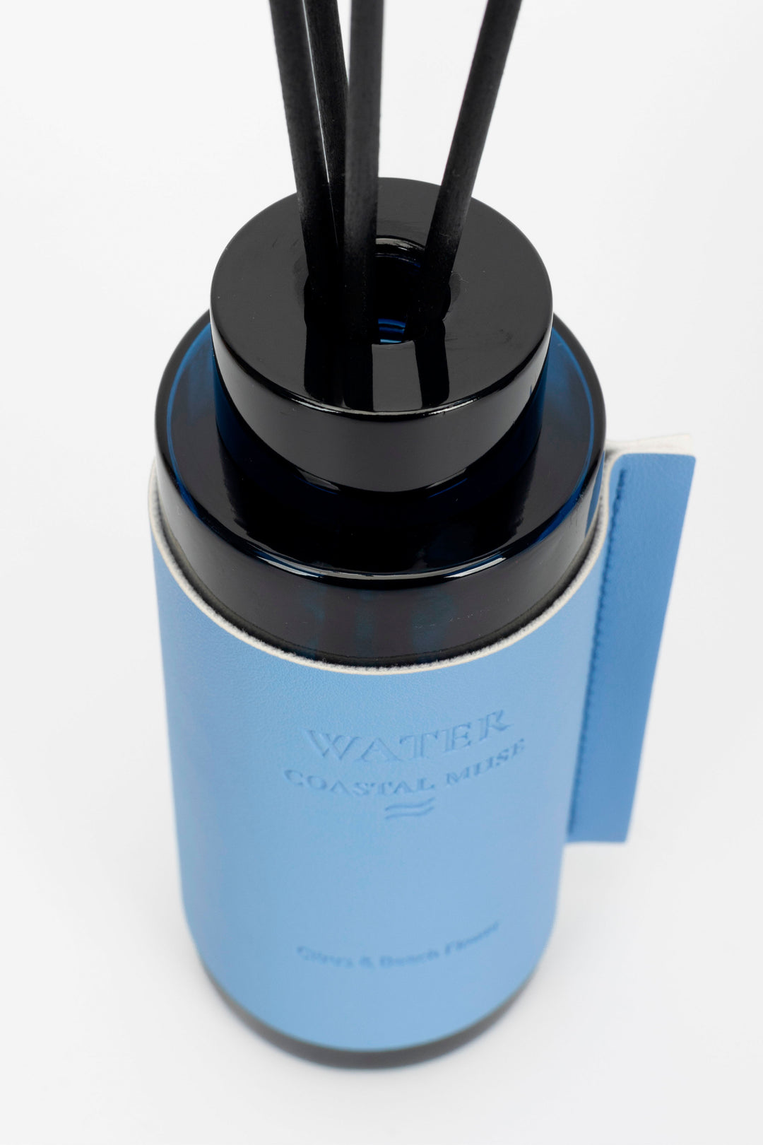 Blue diffuser with black nozzles on a white background