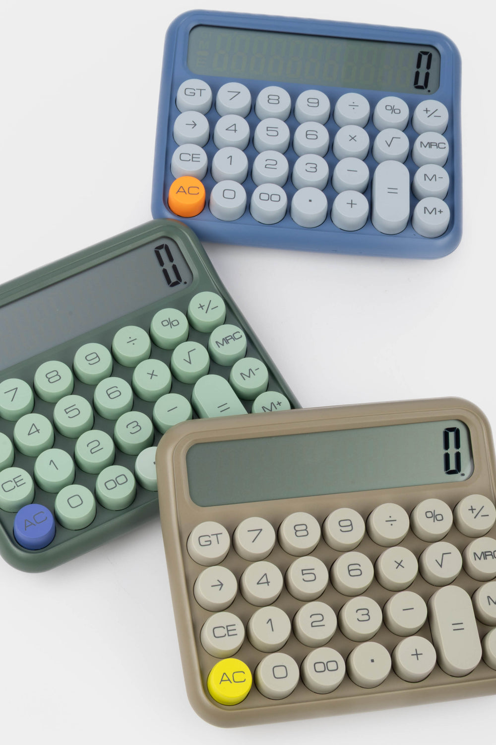 Three calculators in different colors on a white background