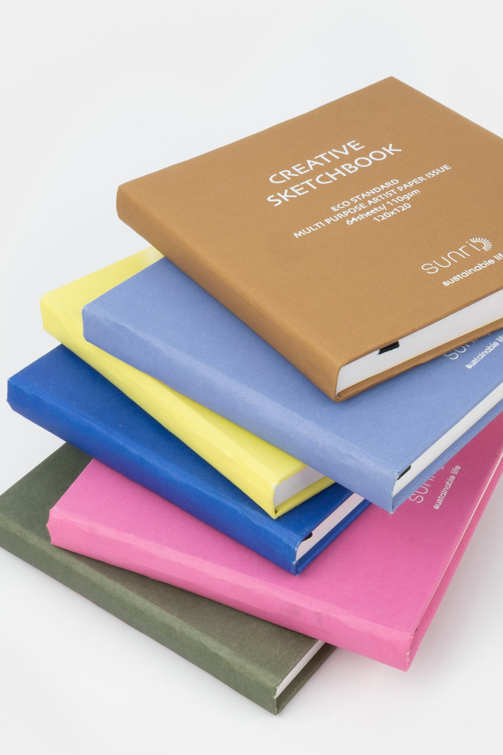 Stack of colorful sketchbooks on a white background