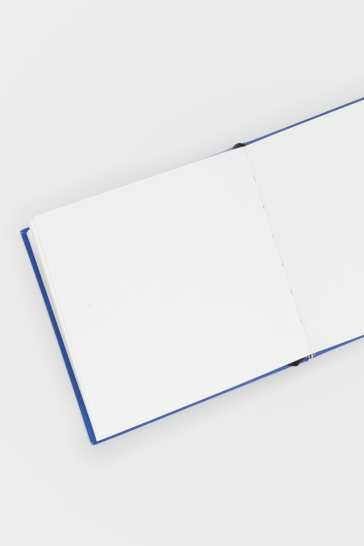 Open sketchbook with blue binding on a white background