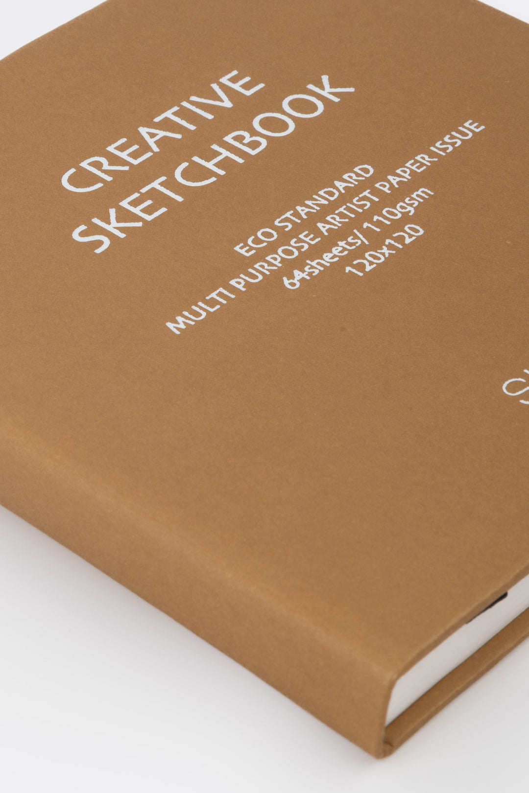 Brown sketchbook with text on a white background