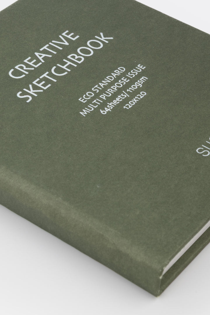 Green sketchbook with text on a white background