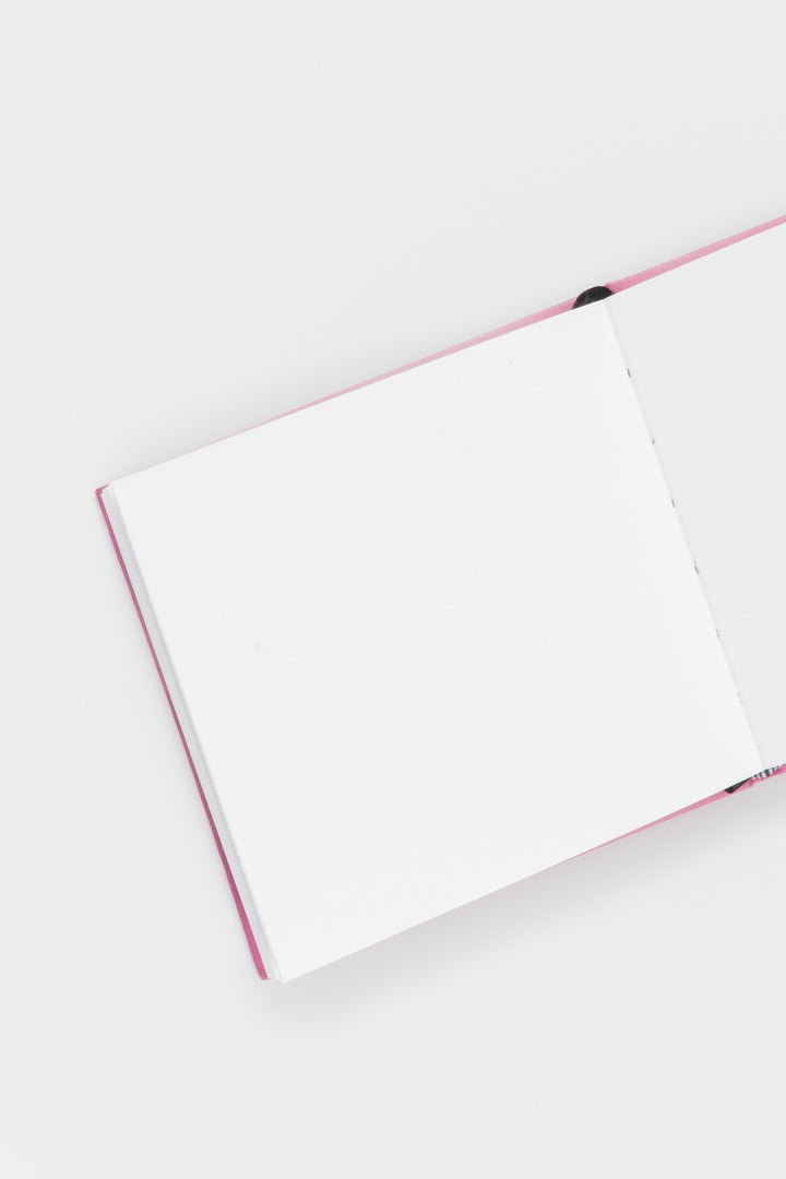 Open notebook with pink binding on a white background