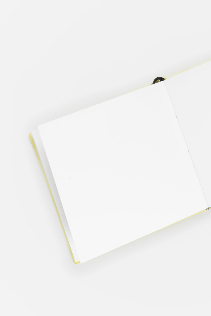 opened sketchbook with yellow binding