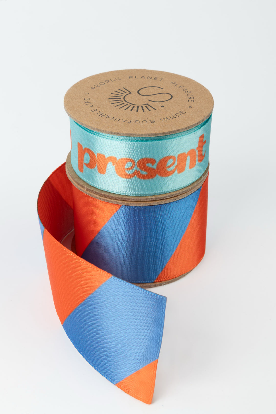 Colorful ribbon with a cylindrical container labeled 'present' on a white background
