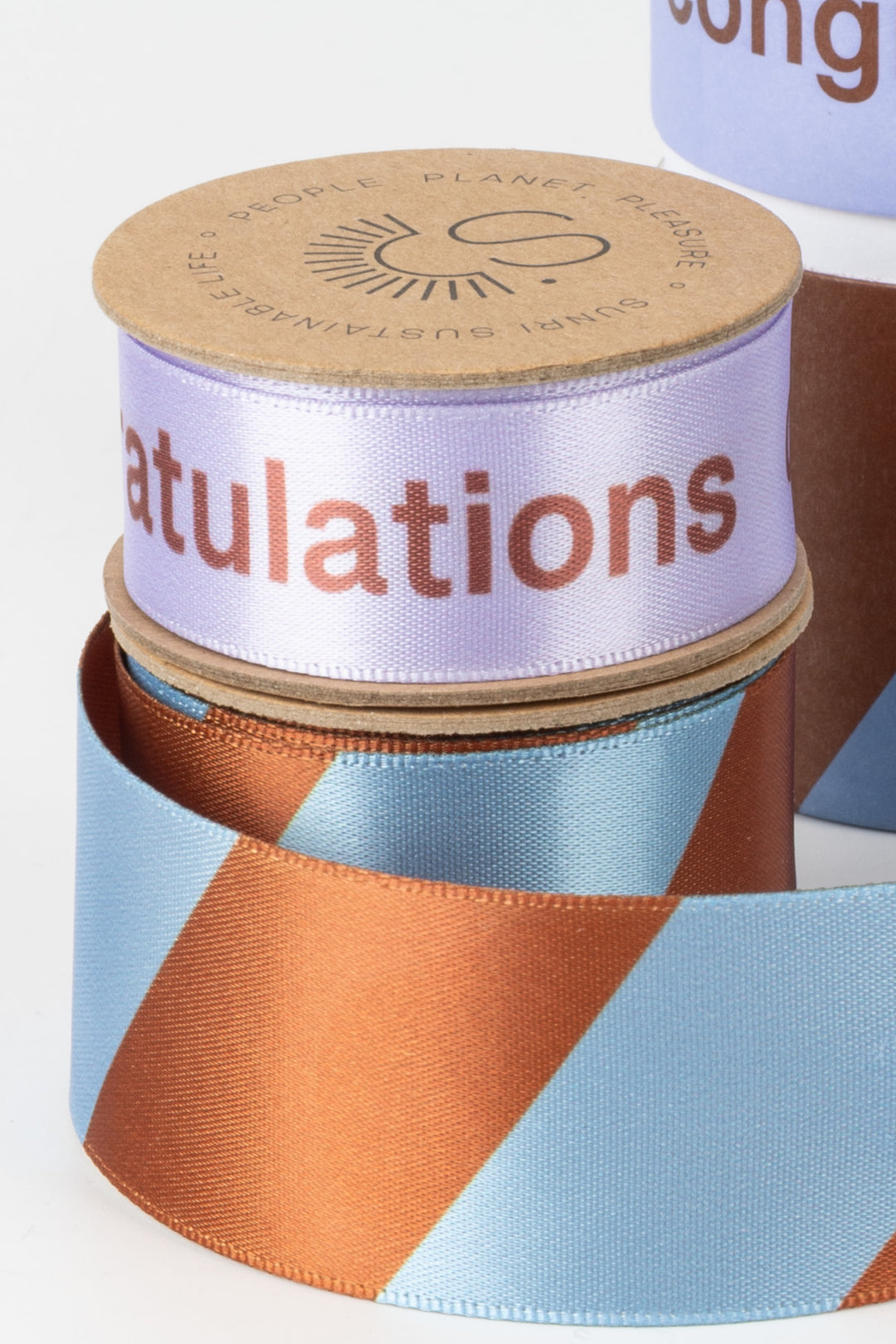 Colorful ribbon with 'Congratulations' text on a cylindrical container.