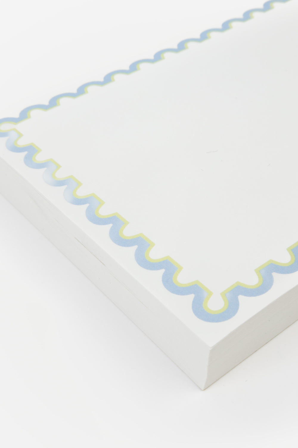 detail of notepad with decorative blue rim 