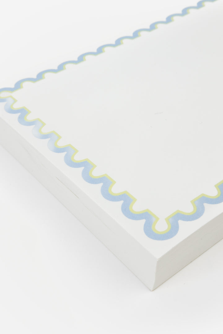 detail of notepad with decorative blue rim 