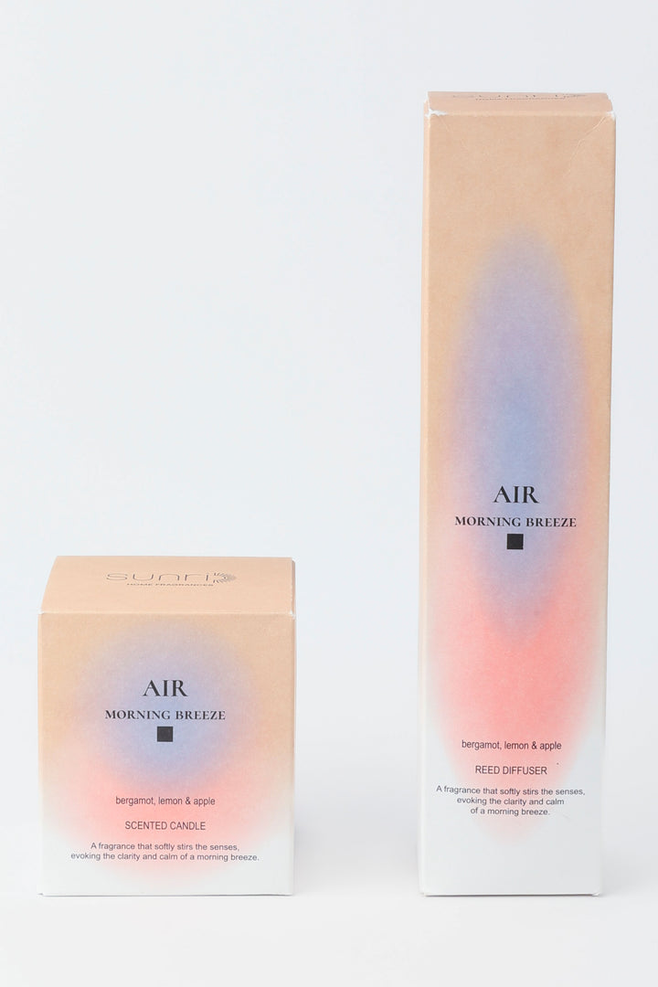 Two boxes of 'AIR Morning Breeze' candles on a light gray background
