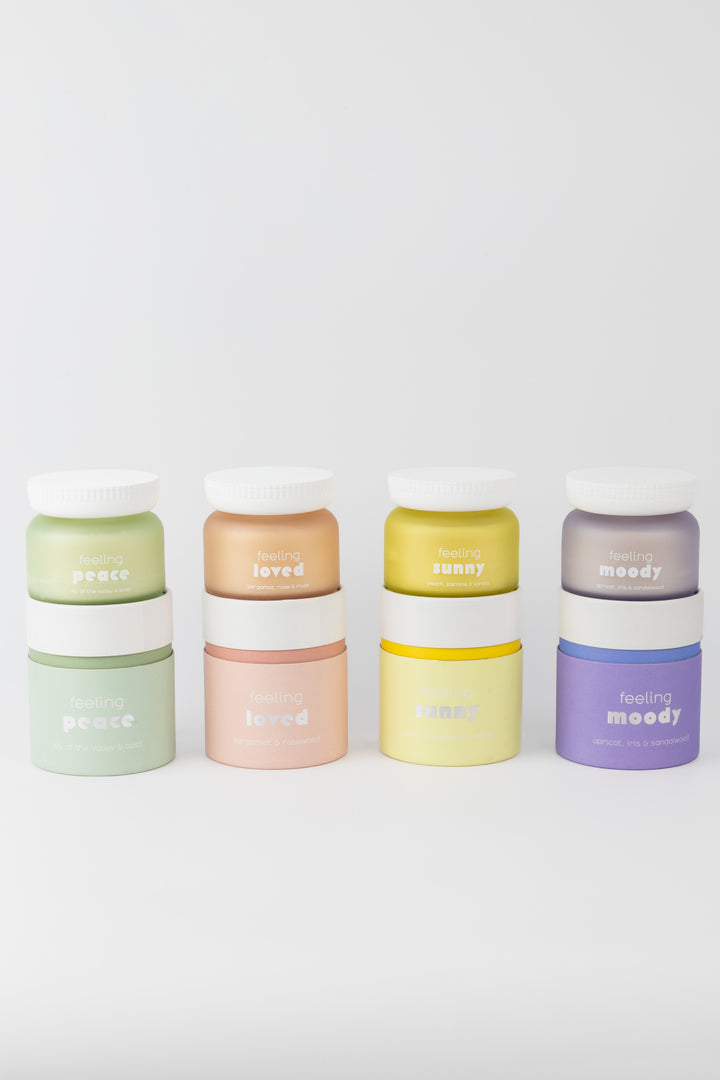 Set of colorful containers with 'feeling' branding on a white background