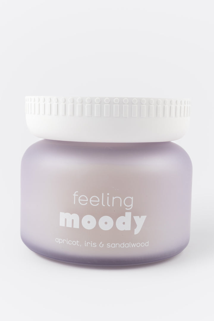 Jar of scented wax with 'feeling moody' text on a white background