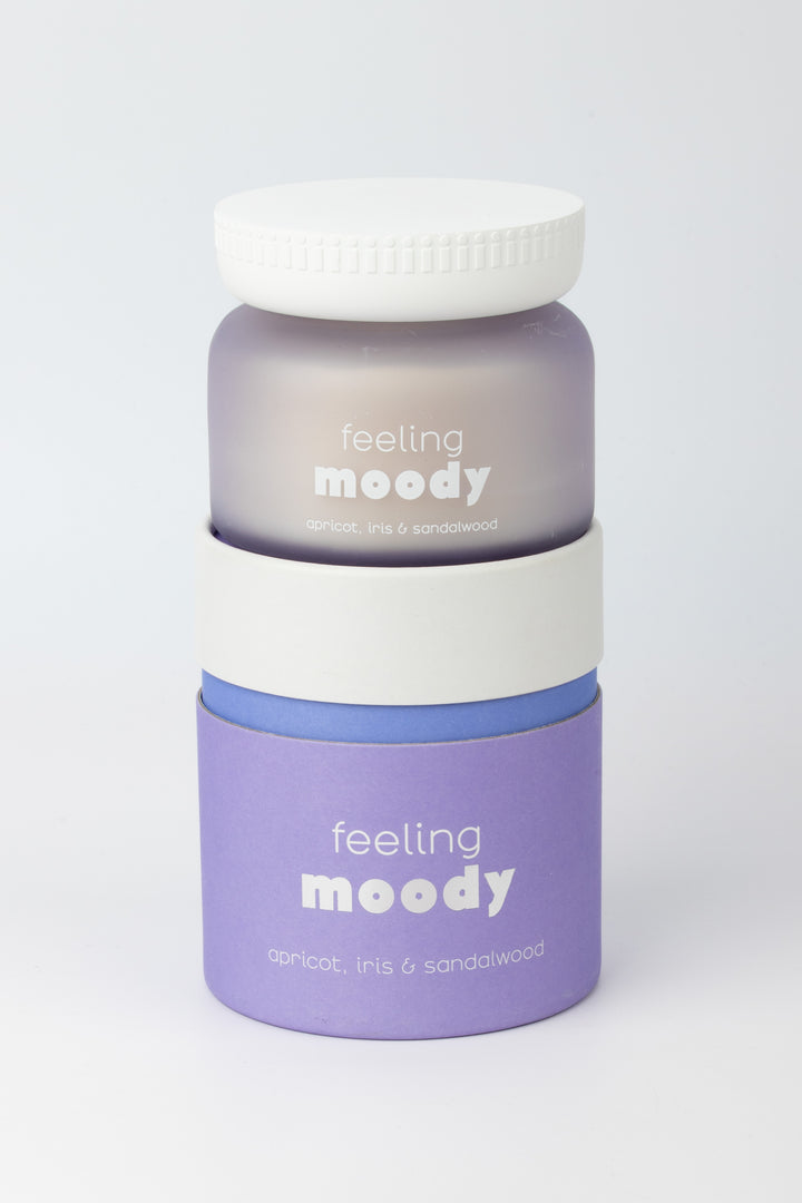 jars labeled 'feeling moody' on top of it's packaging on a light gray background
