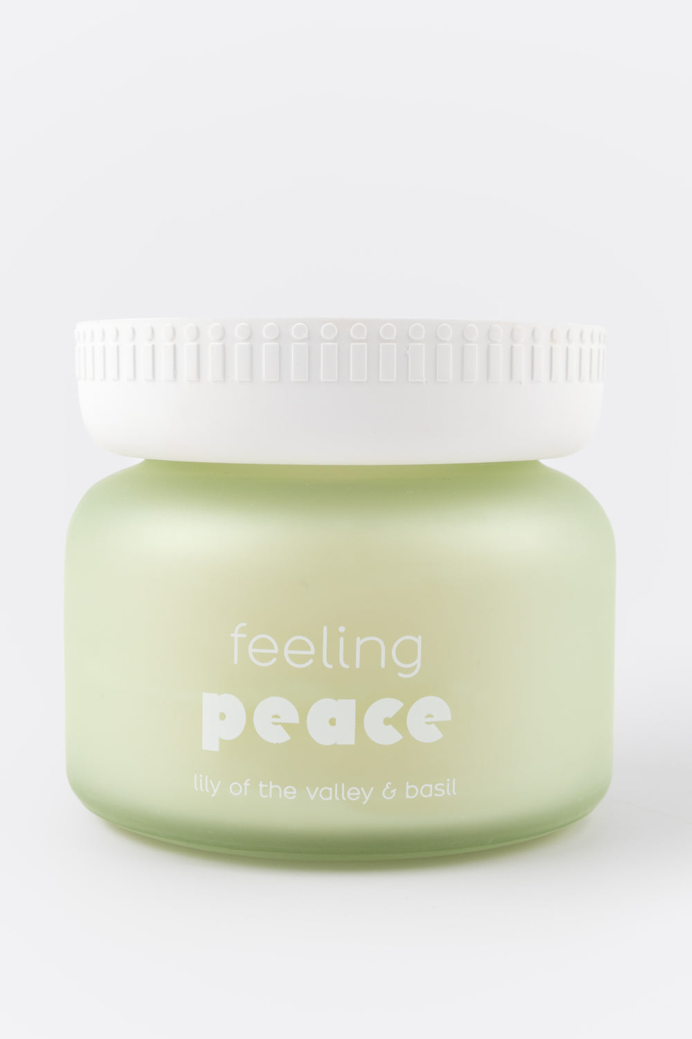 candle jar labeled 'feeling peace' on a white background